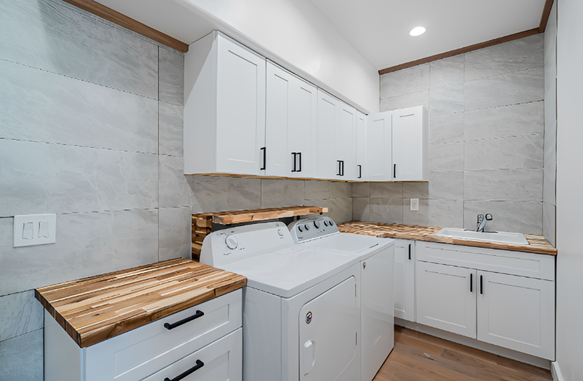 Spacious laundry area with wood countertops
